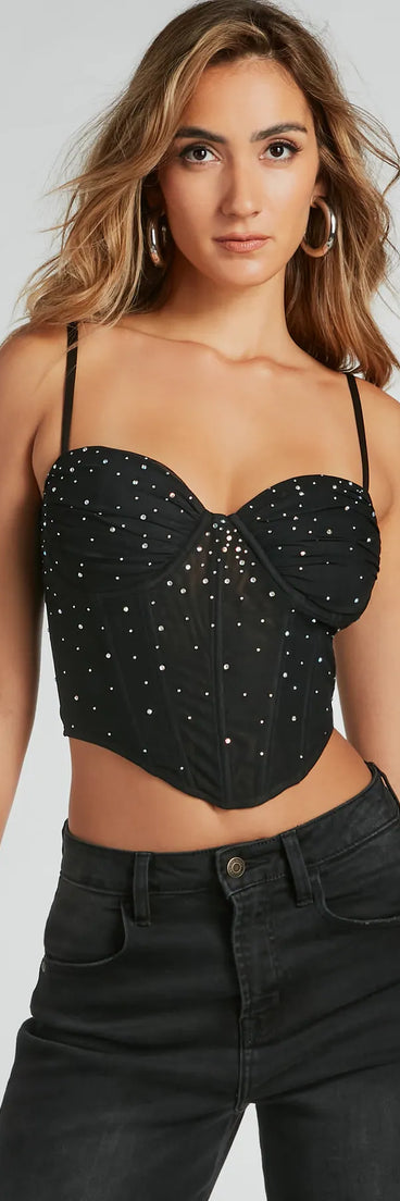 With a structured fit and flattering shape, the Stunned By Luxe Rhinestone Mesh Bustier is a black bustier that adds a sleek, confident edge to your look.